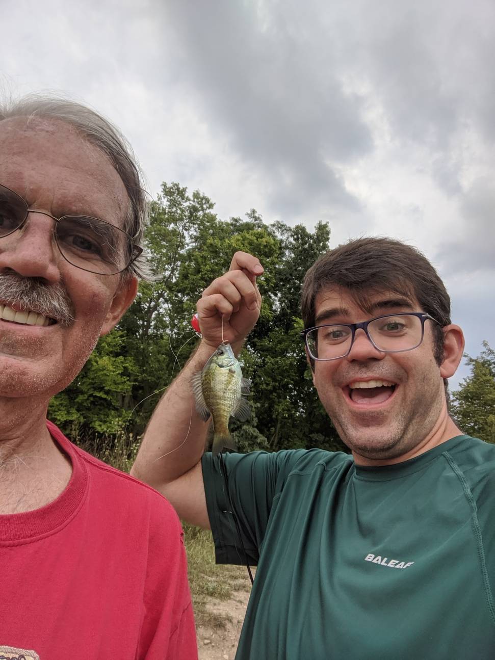 Me and dad pose next to the tiniest fish ever caught